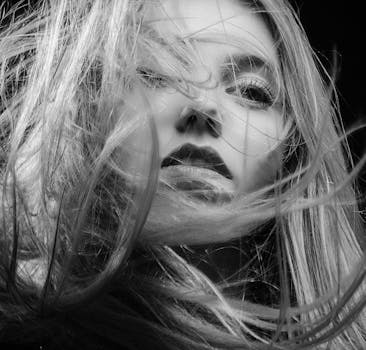 pexels-photo-1055695-1055695 Artistic black and white portrait capturing a woman's beauty and elegance with flowing hair.